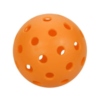 Single orange perforated ball on a white background.