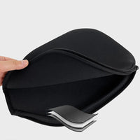 Close-up of a hand unzipping an open black neoprene paddle cover, showing the padded interior.