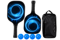 Two black pickleball paddles printed with a blue light spiral, shown with four blue balls and a black carry case with a clear front panel.
